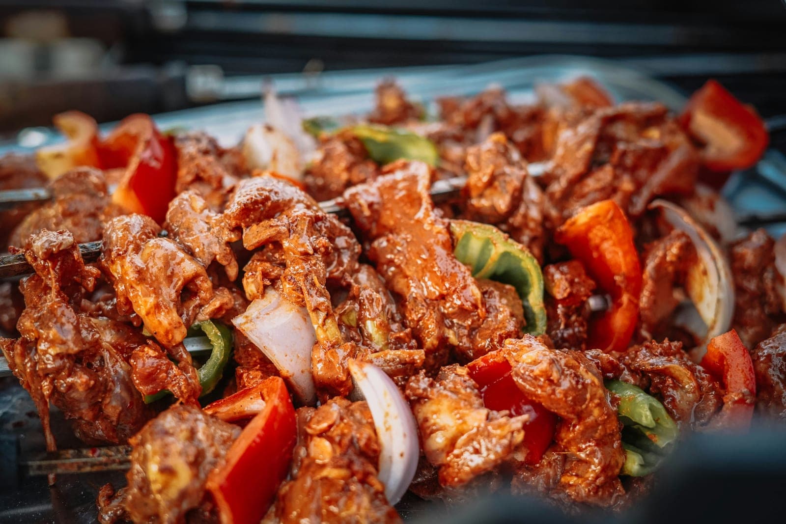 Grilled meat skewers with peppers and onions